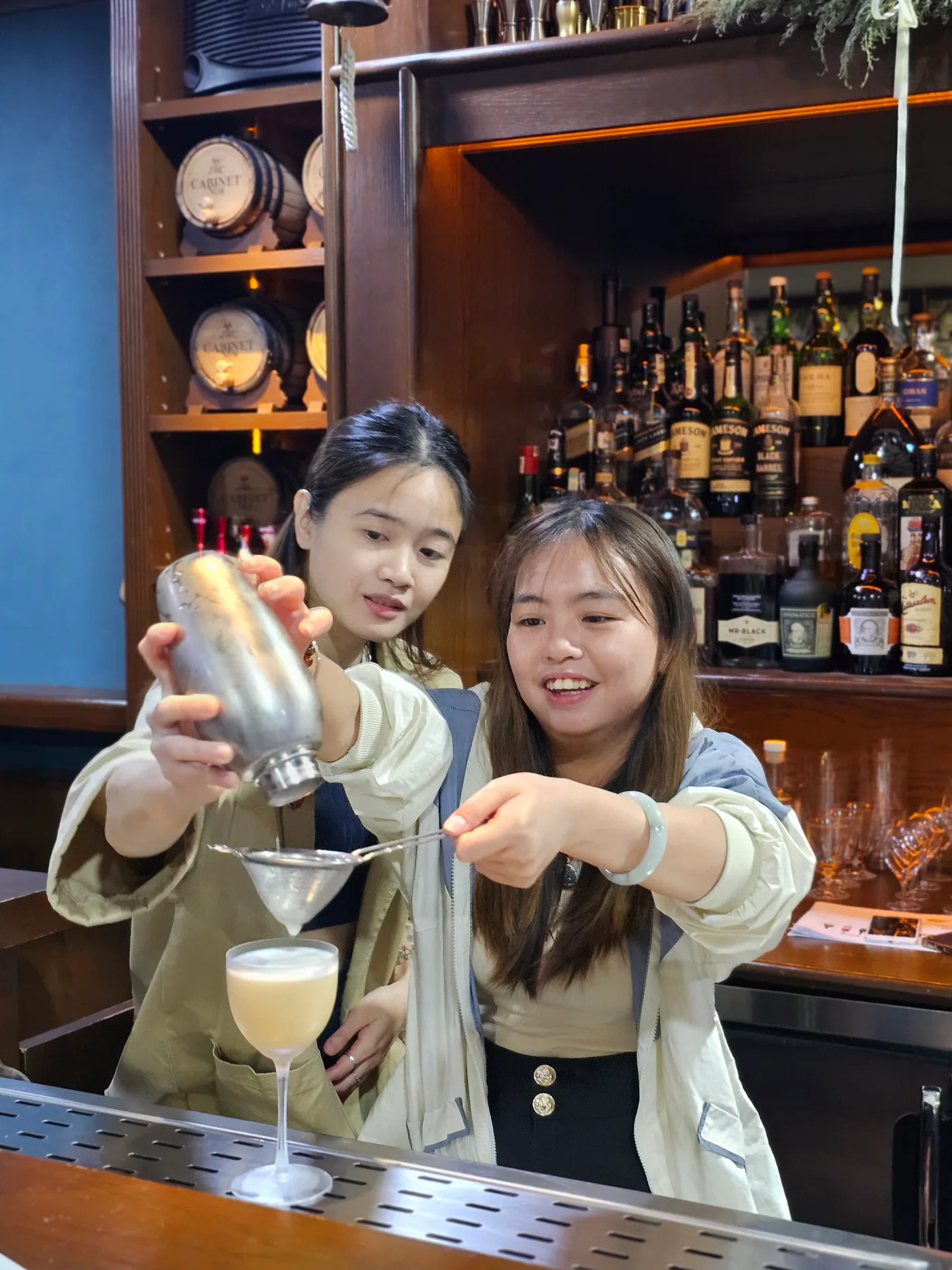 Real JWC mixology learners finishing a cocktail together