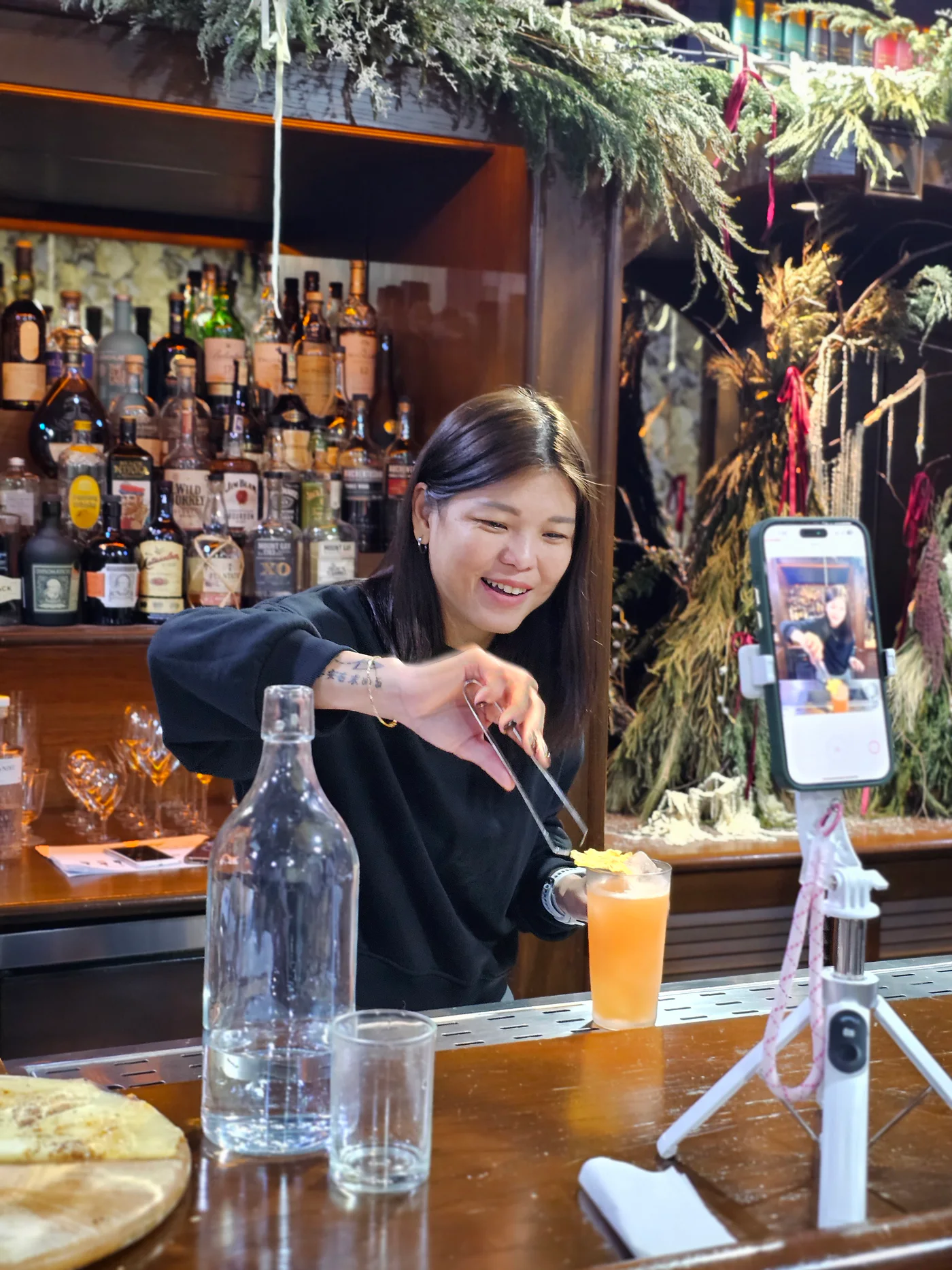 Real JWC learner garnishing and checking a finished cocktail
