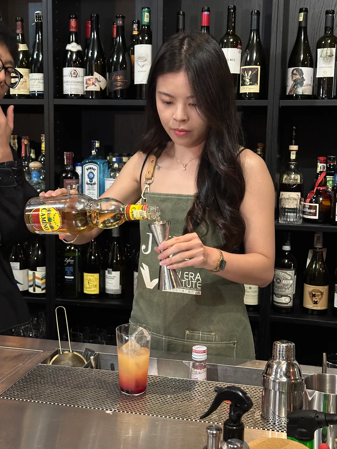 Real JWC mixology learner practising a layered pour